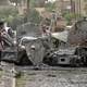 Iraqis and US Army soldiers arrive to the scene after a US Army convoy was attacked by a car bomb in the western part of Baghdad, Iraq, Sunday, May 1, 2005.